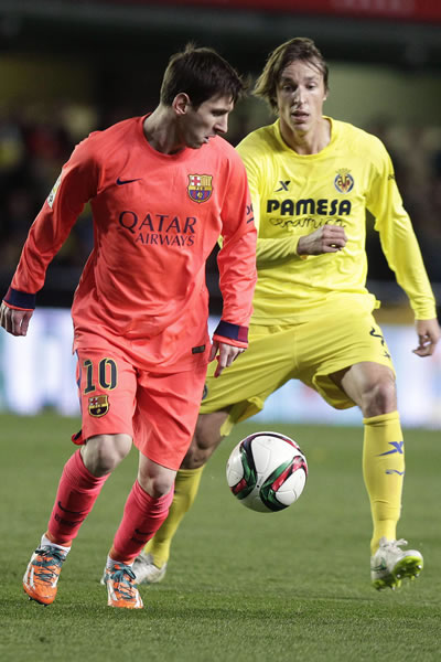 El delantero argentino del FC Barcelona Leo Messi (i) pelea un balón con Tomás Pina, centrocampista del Villarreal. Foto: EFE