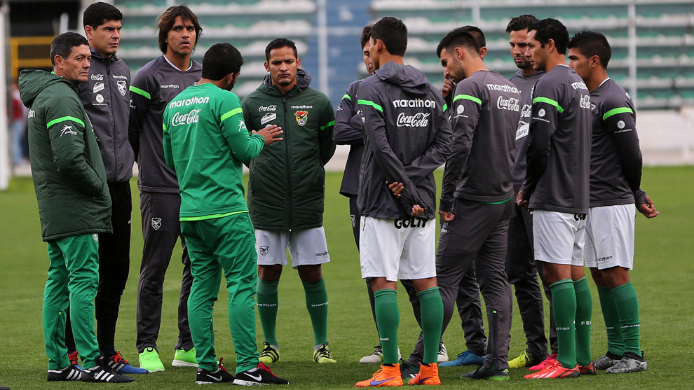 Jugadores de la selección boliviana, junto al técnico Mauricio Soria y uno de sus asistentes, dialogan durante el entrenamiento del equipo verde en La Paz. Foto: EFE